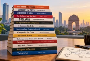 Stack of Indian business books for aspiring entrepreneurs on a wooden desk